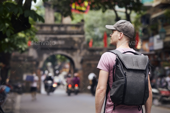 Traveler walking on busy street in Hanoi - Stock Photo - Images