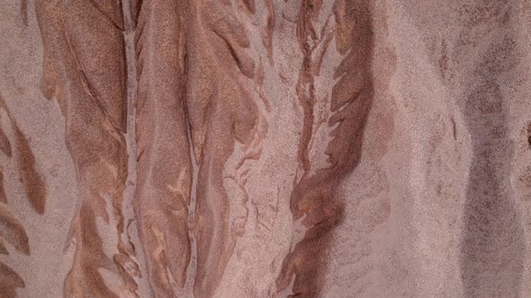 4K Aerial view of rock fissures eroded by water. alt