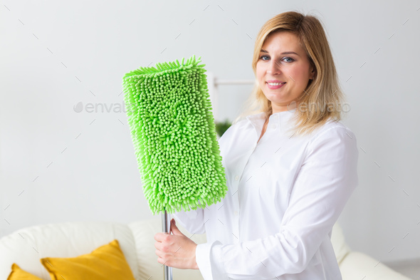 Portrait of housewife woman holds mop pad - cleaning concept - Stock Photo - Images