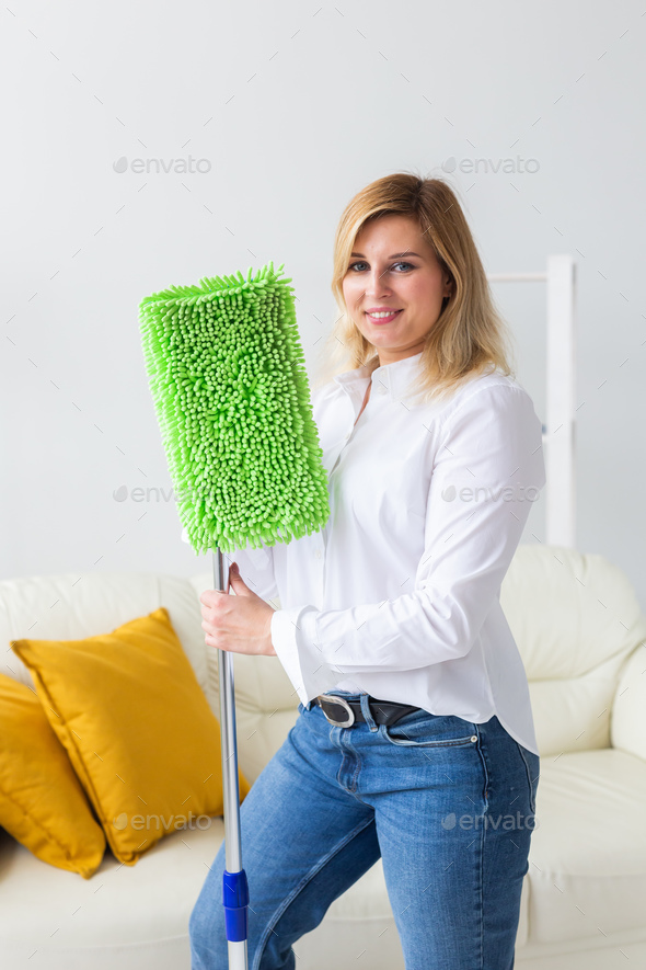 Cleaning woman holding a squeegee mop - house cleaning concept - Stock Photo - Images
