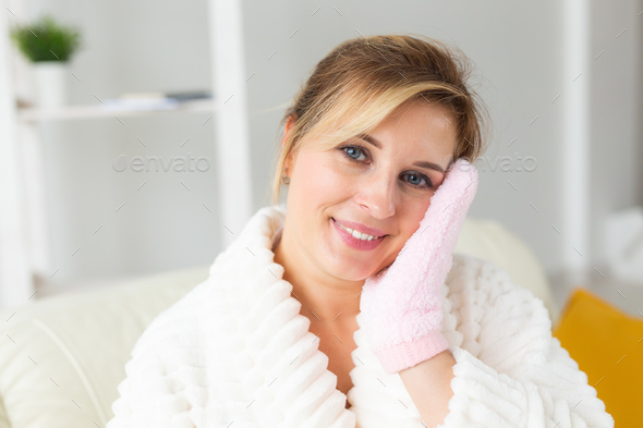 Excited joyful young woman wrapped head in towel holding dry brush shower sponge and doing spa - Stock Photo - Images