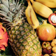 Fresh exotic fruits on green tropical palm leaves background - papaya, mango, pineapple, passion - PhotoDune Item for Sale
