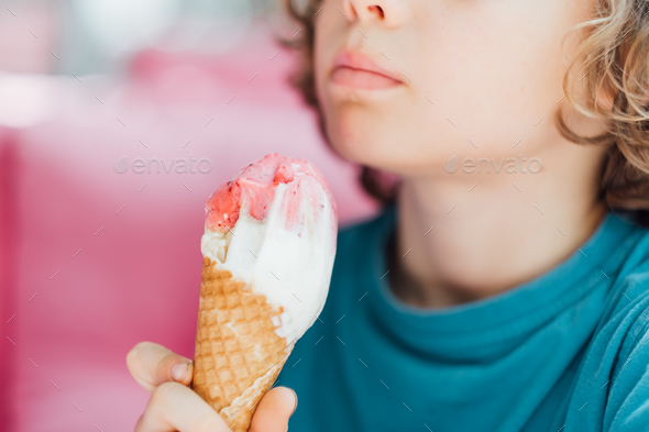 Closeup portrait of boy eating cone ice cream. Child licking ice cream. - Stock Photo - Images