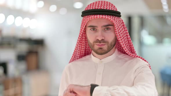 Portrait of Anxious Arab Businessman Waiting, Checking Time  alt