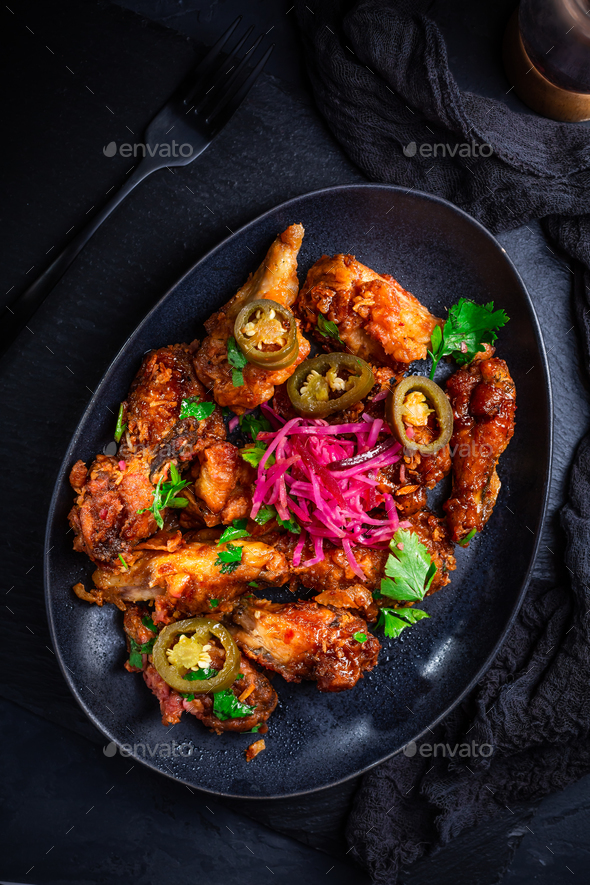 Grilled Lemon and garlic chicken wings with pickled root vegetables  - Stock Photo - Images