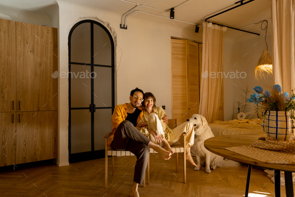Young couple with dog in apartment