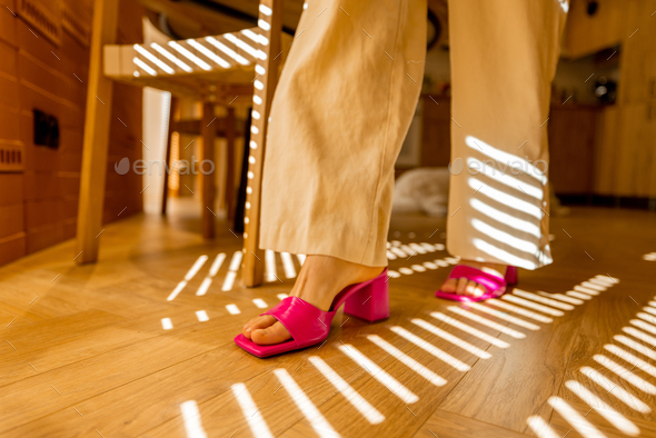 Woman walking on wooden parquet, close-up - Stock Photo - Images