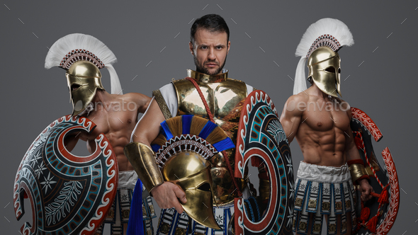 Greek warlord with two comrades against grey background - Stock Photo - Images