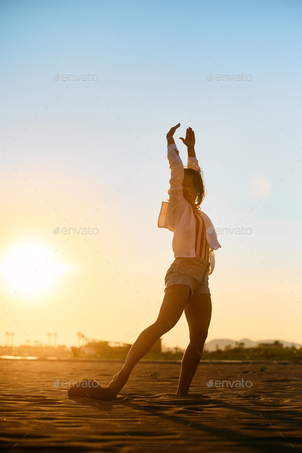 Carefree woman having fun on summer sunset at the beach. - Stock Photo - Images