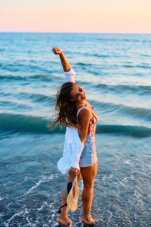Carefree woman enjoying in summer day at the sea. - Stock Photo - Images
