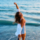 Carefree woman enjoying in summer day at the sea. - PhotoDune Item for Sale