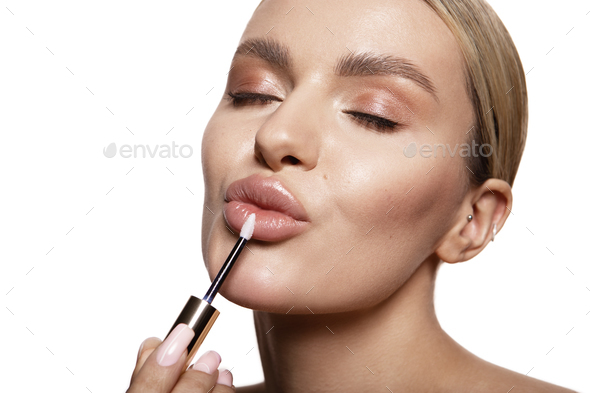 Beauty portrait of model with natural make-up. Fashion shiny highlighter on skin, sexy gloss lips - Stock Photo - Images