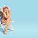 Happy woman sunbathing on a deckchair - PhotoDune Item for Sale