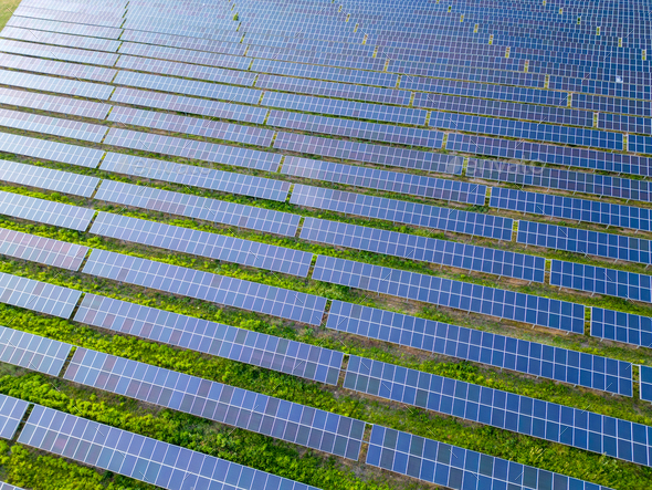 big solar power station on a green meadow aerial view - Stock Photo - Images