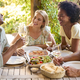 Group Of Smiling Multi-Cultural Friends Outdoors At Home Eating Meal And Drinking Wine Together - PhotoDune Item for Sale