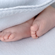 Small, newborn baby feet close up under a blanket - PhotoDune Item for Sale