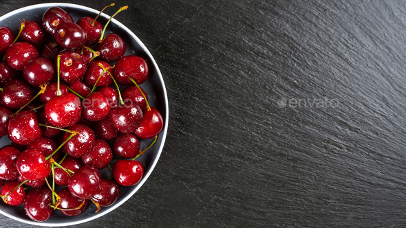 Fresh Red Ripe Sweet Cherry On Plate On Black Slate Background. - Stock Photo - Images