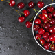 Fresh red ripe sweet cherry with water drops on plate on black slate background. - PhotoDune Item for Sale
