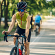 Portrait of a woman riding a bike during a sport cycling race on a sunset - PhotoDune Item for Sale