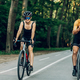 Couple riding bicycles outside of the city and wearing helmets and sunglasses - PhotoDune Item for Sale