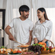 Happy smiling couple cooking together and healthy eating concept - couple cooking food at home - PhotoDune Item for Sale