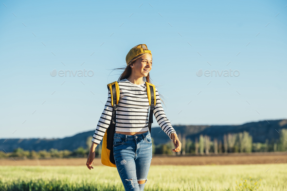 Outdoor portrait of a beautiful young blonde woman in a yellow cap and a bracket on her teeth. - Stock Photo - Images