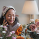 Happy and attractive mature Asian woman enjoying with her online flower arrangement workshop at home - PhotoDune Item for Sale