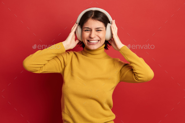 Excited woman listening to music - Stock Photo - Images