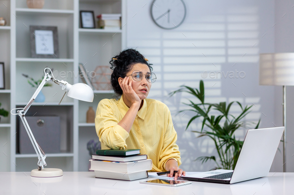 Overworked and overwhelmed woman studying remotely, hispanic woman upset sitting at desk inside - Stock Photo - Images