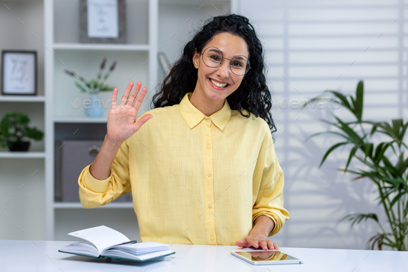 Video call online meeting with colleagues, successful and happy hispanic woman having fun with - Stock Photo - Images