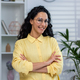 Portrait of young beautiful hispanic at home, woman with curly hair in glasses and yellow shirt - PhotoDune Item for Sale