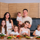 A large family  together prepare a salad for lunch in a modern kitchen. - PhotoDune Item for Sale