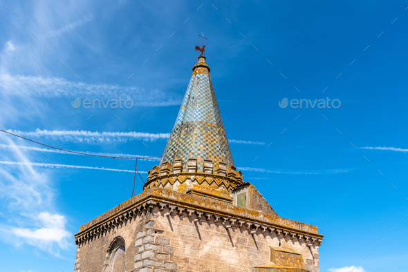 Tower of the Cathedral of Evora. Low angle view against blue sky - Stock Photo - Images
