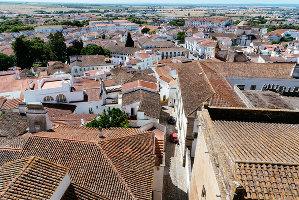 Cityscape of Evora with typical houses painted in white and ceramic tiled roofs - Stock Photo - Images