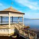 Scenic view of an open-air round building on a lake in Tuscany, Italy on a sunny day - PhotoDune Item for Sale