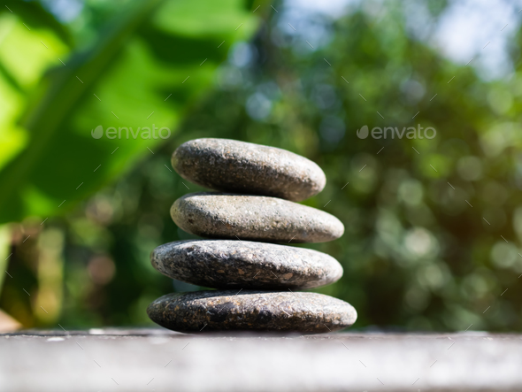 Stack Stone on Blur Plant Growth Tree wit Bokeh Background - Stock Photo - Images