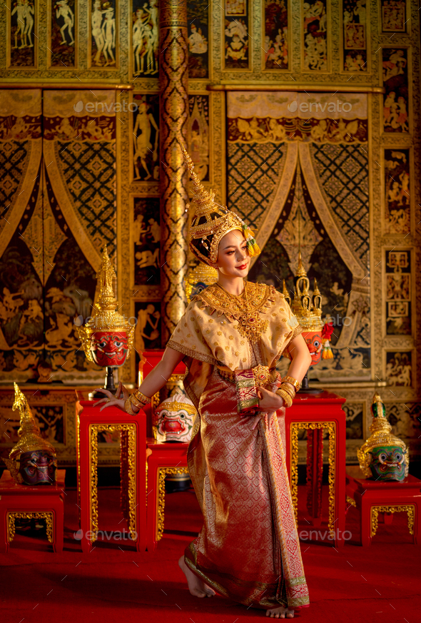 Vertical image of Asian woman wear Thai ancient traditional dress action of dancing in front of Khon