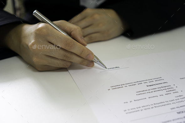 A female financial officer is signing a contract document between Lex and a real estate company, the