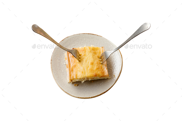 Sharing a piece of lemon cake with two forks and copy space isolated white with copy space