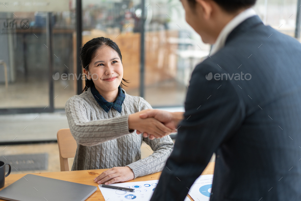 Successful business people having a hand shake after the deal was done.
