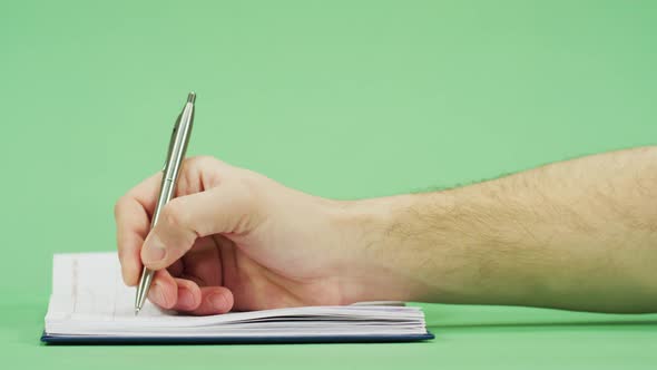 Side view of a man's hand writing alt