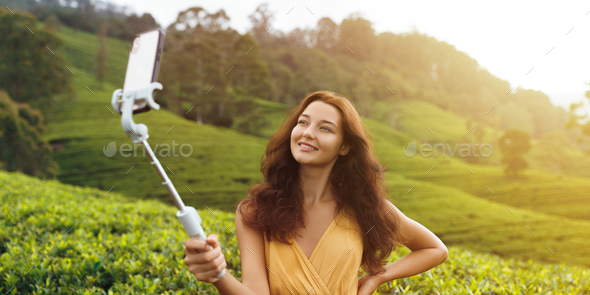 Asian Travel Vlogger Woman with Mobile Phone Camera During Trip to Green Tea Hills in Sri Lanka. - Stock Photo - Images