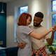 Joyful young diverse married couple dancing having fun in living room at home - PhotoDune Item for Sale