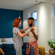 Joyful young diverse married couple dancing having fun in living room at home - PhotoDune Item for Sale