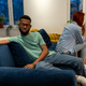 Unhappy young interracial couple sit separately on sofa at home not talking after fight - PhotoDune Item for Sale