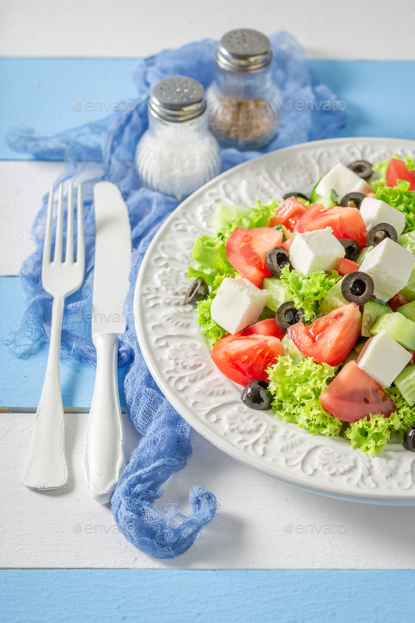 Diet and tasty Greek salad seasoned with olive oil. - Stock Photo - Images