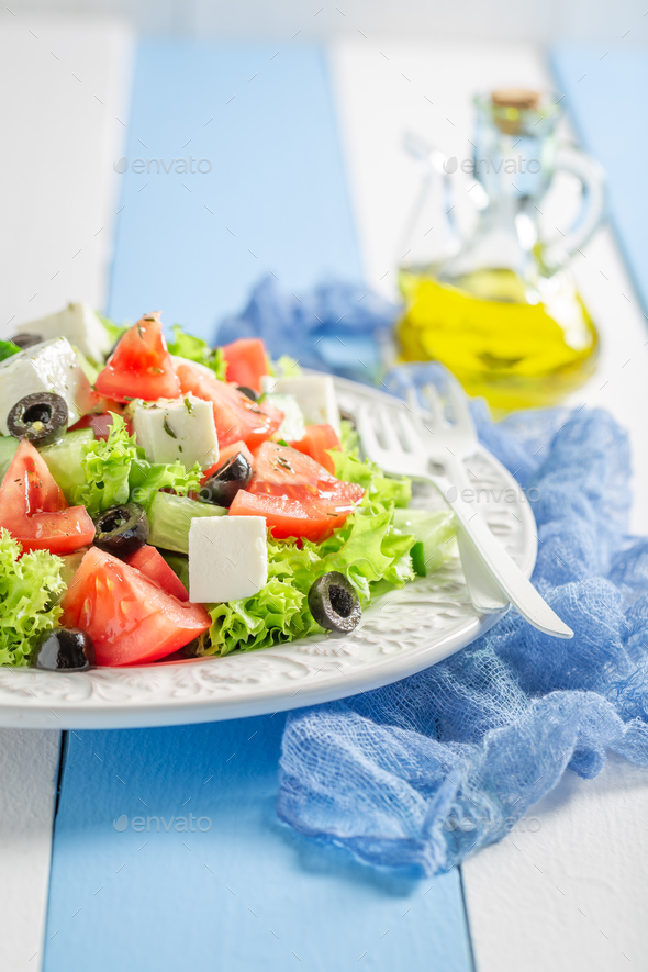 Diet and tasty Greek salad with lettuce, tomatoes and onion. - Stock Photo - Images