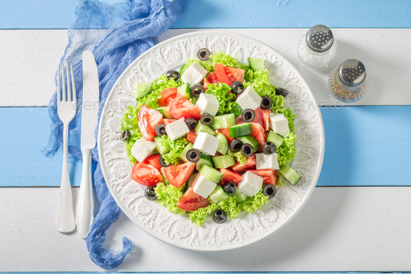 Full of vitamins Greek salad with olives, feta and lettuce. - Stock Photo - Images