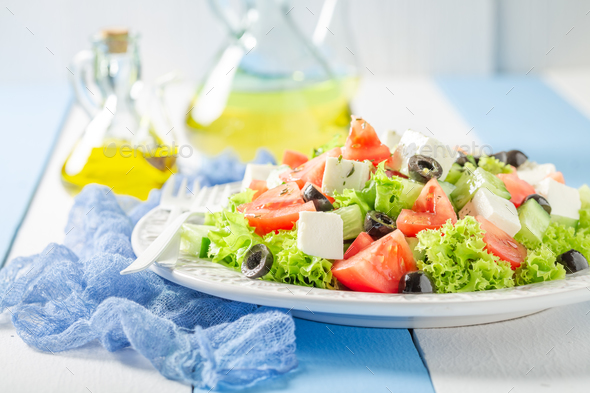 Fresh and healthy Greek salad seasoned with olive oil. - Stock Photo - Images