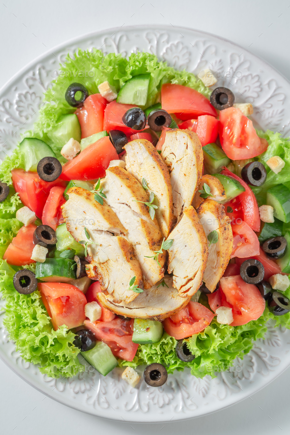 Healthy and classic Caesar salad with chicken, lettuce and tomatoes. - Stock Photo - Images
